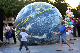 Children get a closer look of a large inflatable globe during the May 12th General Conference Climate Vigil at Oregon Convention Center Plaza in Portland. Photo by Kathleen Barry, UMNS