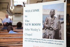The sign at the entrance of the New Room, celebrates the ministry of John and Charles Wesley yesterday and today. Photo by Kathleen Barry, United Methodist Communications.