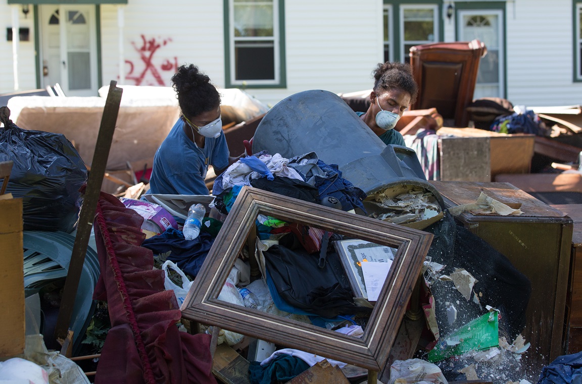 Jeremain (left) and Jeremaih Robinson pile up ruined furnishings from a home that was heavily damaged by flooding in Baton Rouge, La. The 16-year-old twins were part of a volunteer team from First United Methodist Church in Baton Rouge. Photo by Mike DuBose, UMNS.