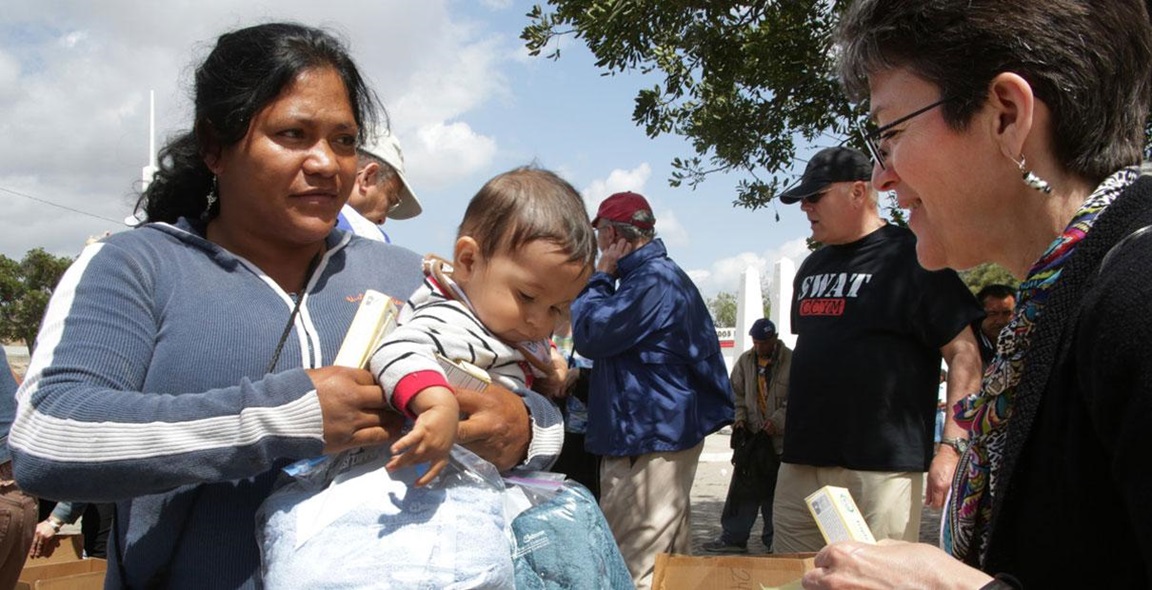 United Methodist bishops help families during an immersion experience at the U.S./Mexico border in May, 2013. File photo by Kathleen Barry, UMNS. 
