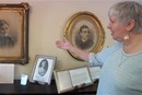 Donna Miller of Historic St. George's United Methodist Church in Philadelphia points out images of Ann and Anna Jarvis at the church. Video image by United Methodist Communications.