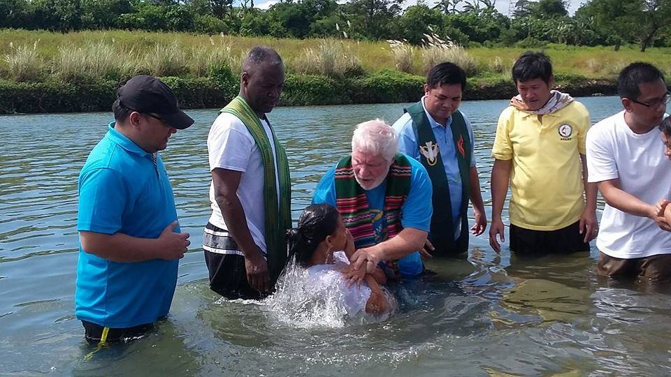 The Rev. Joey Galinato of Good Samaritan United Methodist Church, the Rev. Michael McQueen of St. James United Methodist Church and the Rev. Ronny Branen of Prospect United Methodist Church, all from the North Georgia Conference, join in baptizing 47 people in a river in Angat, Philippines. Photo by the Rev. Joey Galinato
