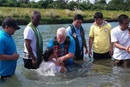 The Rev. Joey Galinato of Good Samaritan United Methodist Church, the Rev. Michael McQueen of St. James United Methodist Church and the Rev. Ronny Branen of Prospect United Methodist Church, all from the North Georgia Conference, join in baptizing 47 people in a river in Angat, Philippines. Photo by the Rev. Joey Galinato