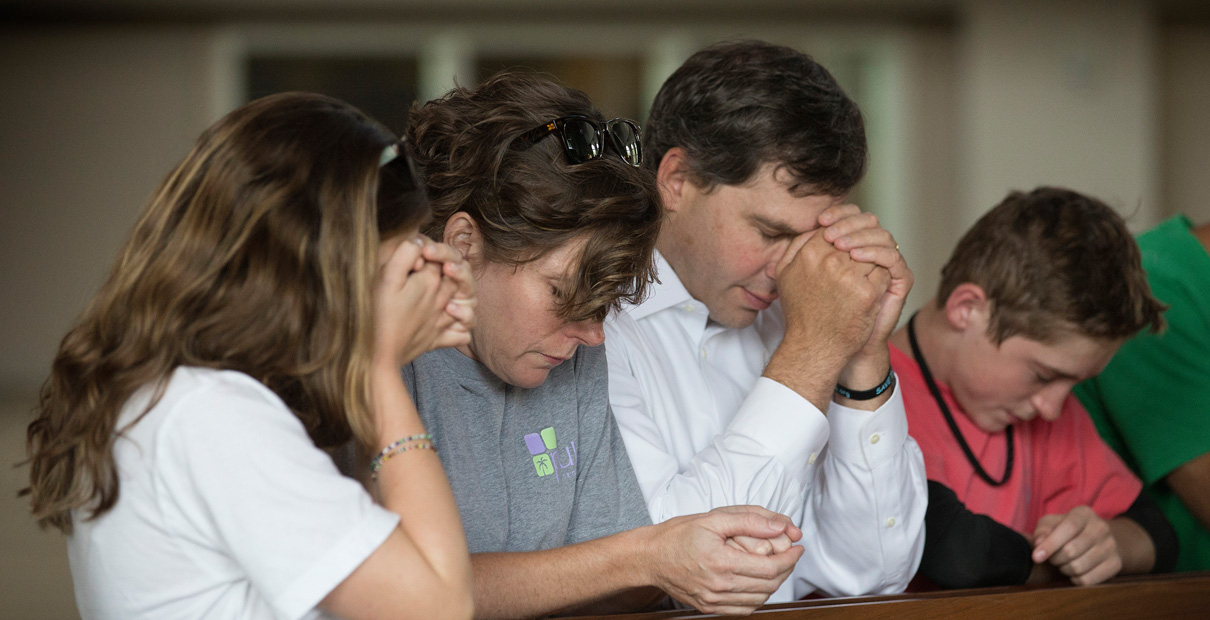 Young adults whose parents shared the importance of their faith are far more likely to continue in church. Members of the Bonn family pray during a 2014 service at Christ United Methodist Church in Franklin, Tenn., to lift up those facing the Ebola crisis in West Africa. Photo by Mike DuBose, United Methodist Communications.