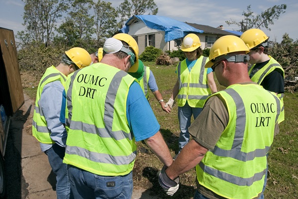 Volunteers from Ozark (Mo.) United Methodist Church's disaster response team pray before beginning to clear storm damage in Joplin, Mo. File photo by Mike DuBose, United Methodist Communications.