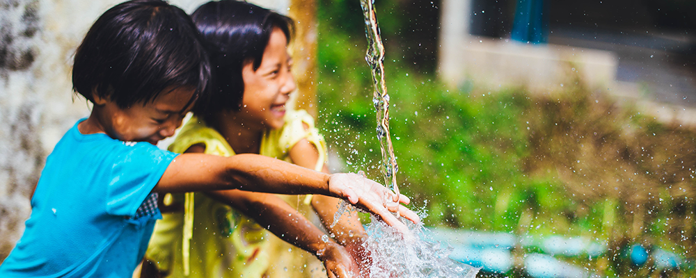 Children playing in clean water - Stock photo.