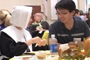 An international student eats a traditional Thanksgiving meal with members of Athens FUMC.