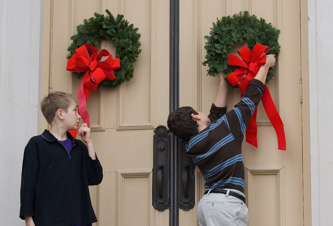 Children hang wreaths on the sanctuary door at Belmont United Methodist Church in Nashville, Tenn., during the church's annual Hanging of the Greens service. Photo by Mike DuBose, United Methodist Communications.