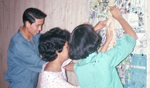 Rafael Santos, MarLu Primero, and Fely Mariano prepare for worship at Christmas Institute 1964.