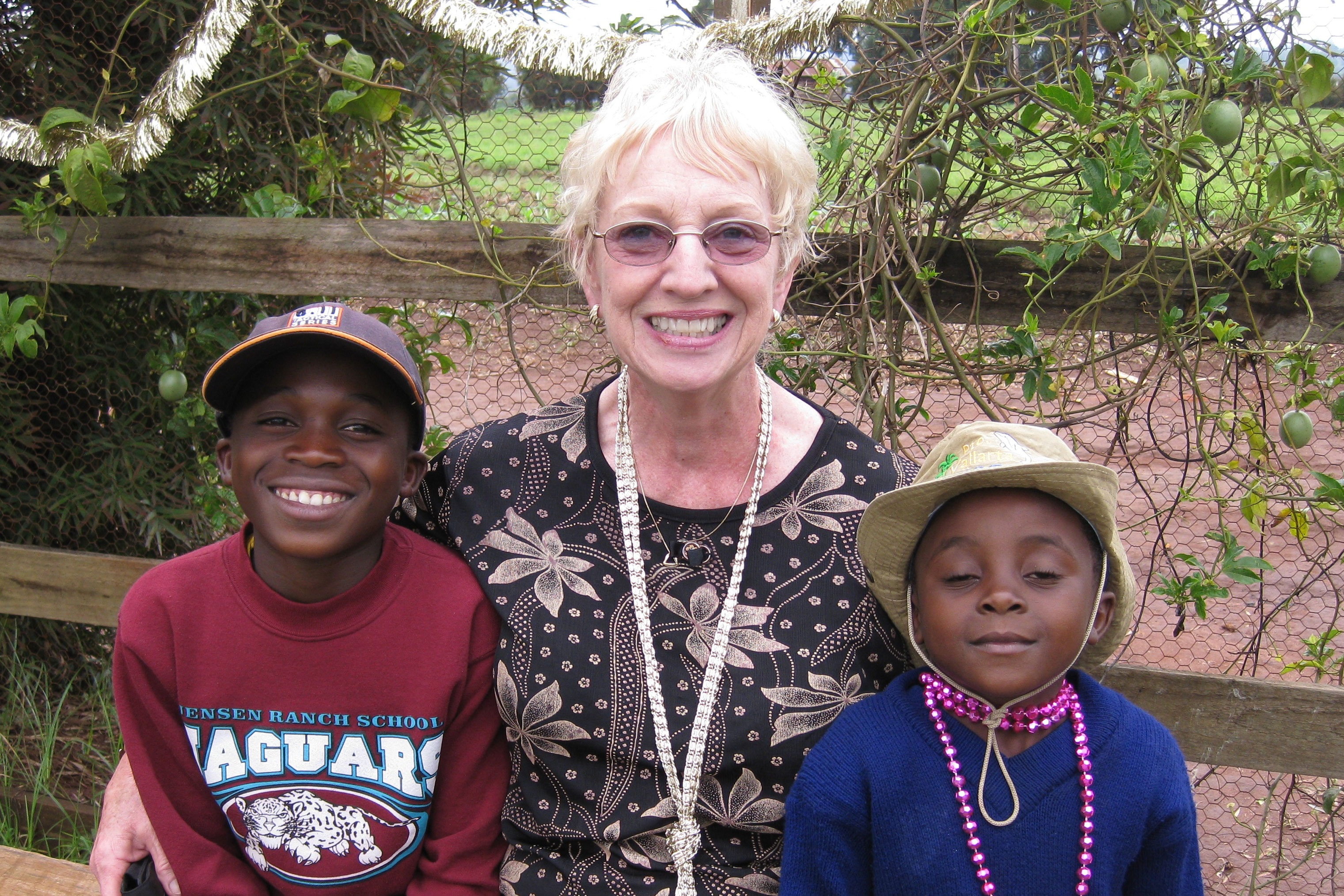 Kay 'Bibi Kay' Oursler sits with two children who live at Sunrise Children's Home in Tanzania, the orphanage Oursler founded. Photo courtesy of Kay Oursler.