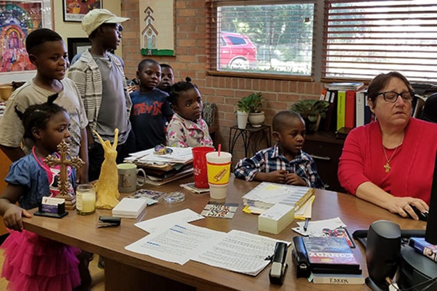 Rev. Karen Jones (far right) helping African refugees at First United Methodist Church in Center, Texas. Photo courtesy of Shannon Martin, Texas Annual Conference.