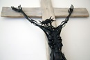 An abstract metal crucifix hangs on the wall outside the chapel at Sarum College in Salisbury, England. Photo by Kathleen Barry, United Methodist Communications.