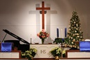 The Glendale United Methodist Church sanctuary in Nashville, Tennessee, is decorated for Advent with symbols of the season, including poinsettias and a Christmas tree.