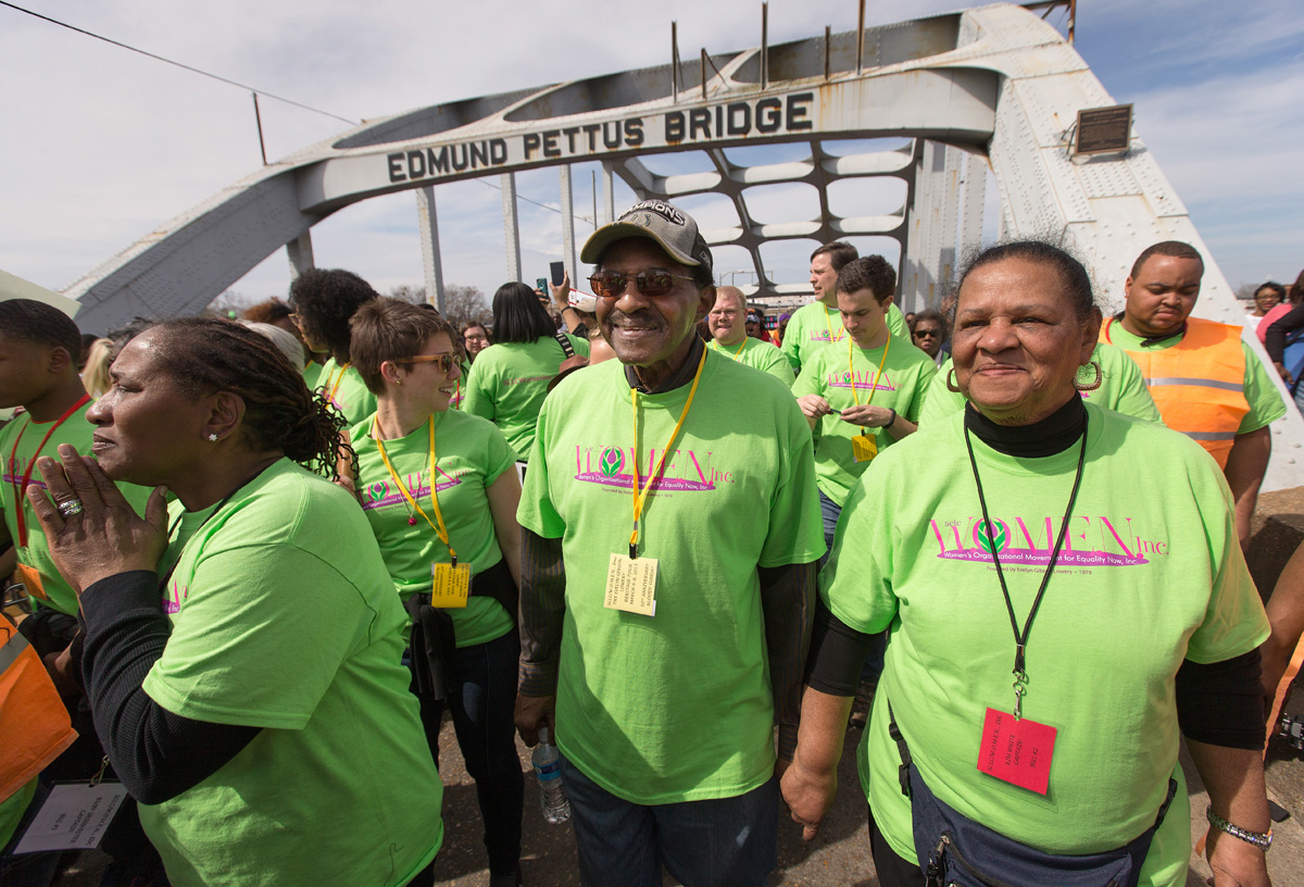 Bishop Woodie W. White (center) crosses the Edmund Pettus Bridge in Selma, Alabama, during the 50th anniversary observance in 2015 of Bloody Sunday. With him are his wife, Kim (right), Ruby Shinhoster and Beth Clarke. Photo by Mike DuBose, UM News.