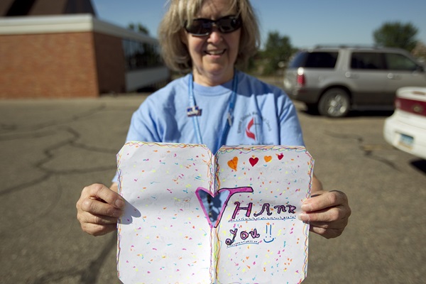 Heather Ellis displays a thank you note from students at Sawyer (N.D.) Elementary School who received backpacks and school supplies from Vincent United Methodist Church in Minot, N.D. Photo by Mike DuBose, UMNS