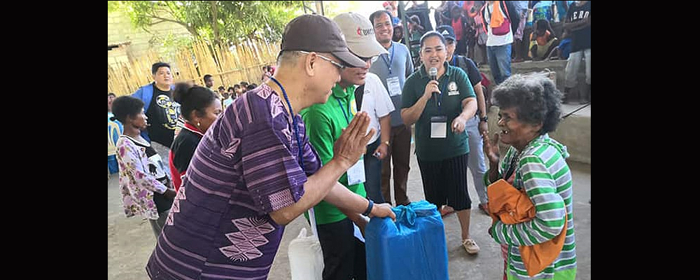 Manila Area Bishop Ciriaco Q. Francisco (left) and Jestril Alvarado, West Pampanga District superintendent, help distribute food to Aeta communities in Floridablanca in the Pampanga province of the Philippines. The United Methodist Committee on Relief issued a $100,000 grant to provide support for 860 indigenous families affected by a deadly earthquake. 