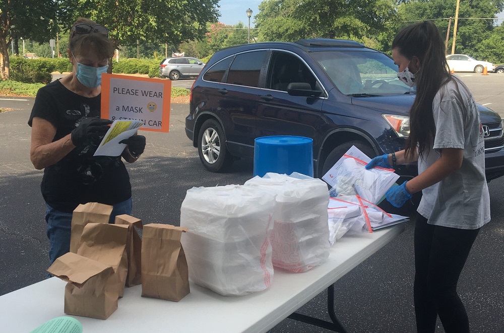 Families drive through to pick up VBS supplies and dinner at Mount Pleasant United Methodist Church. Photo courtesy of Mount Pleasant UMC