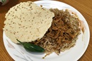 A plate of chicken mole, Mexican rice and tortillas prepared by Bilha Alegria