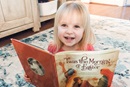 Finley Howell, 3, daughter of Shawn Howell and the Rev. Ricky Howell, a pastor in the  South Carolina Conference of The UMC, enjoys "Twas the Morning of Easter" by Glenys Nellist. Photo from 2021 by Shawn Howell.