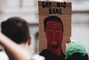 Sign reads "Say his name," and has a depiction of George Floyd. Photo via GCORR.