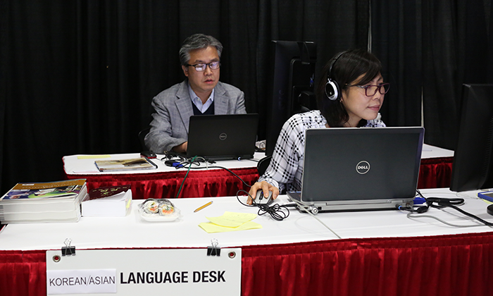 (From left) The Rev. Jacob Lee and Joo Kim work the Korean/Asian-language desk during the 2016 United Methodist General Conference in Portland, Ore. Photo by Kathleen Barry, United Methodist Communications Kathleen Barry