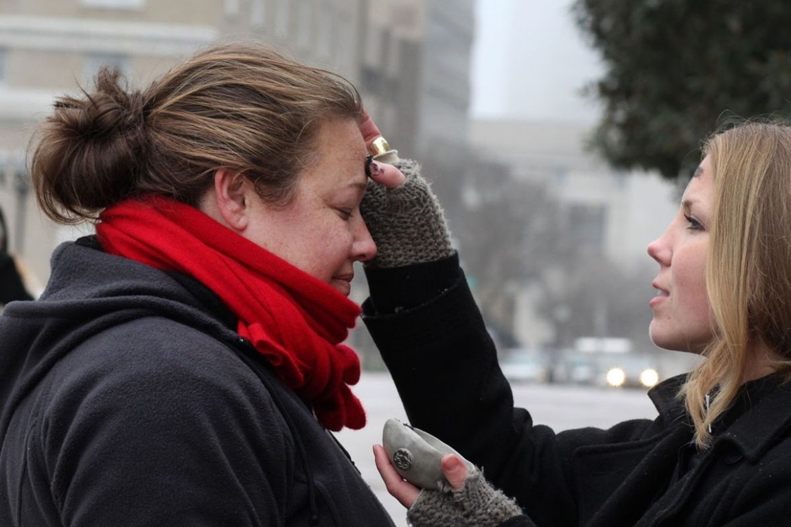 The Rev. Ingrid McIntyre receives ashes from street chaplain Lindsey Krinks on a Nashville, Tenn., street for Ash Wednesday. File photo by Kathleen Barry, United Methodist Communications.