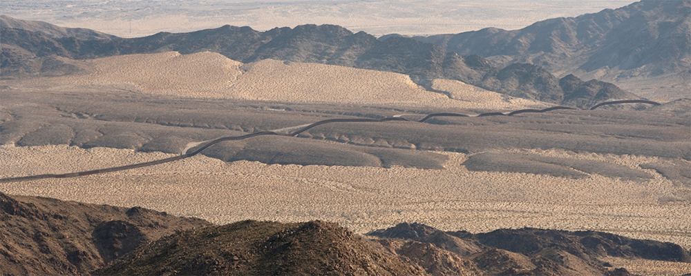 A section of the border fence between the U.S. and Mexico stretches across a valley in the Sonoran Desert near La Rumorosa, Mexico. Photo: Mike Dubose, UMNews.