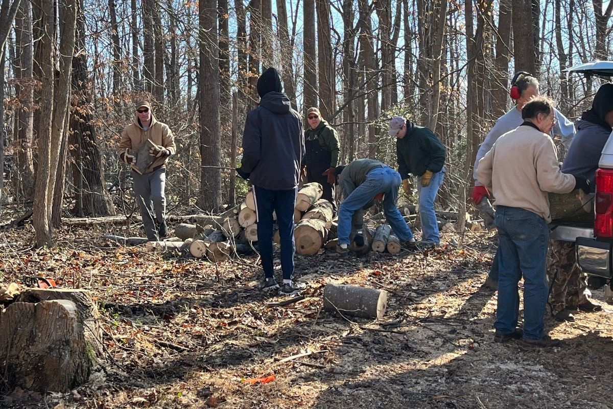 Ebenezer United Methodist Church members turn fallen tress into much-needed firewood for their neighbors. Photo by Bo Tye.