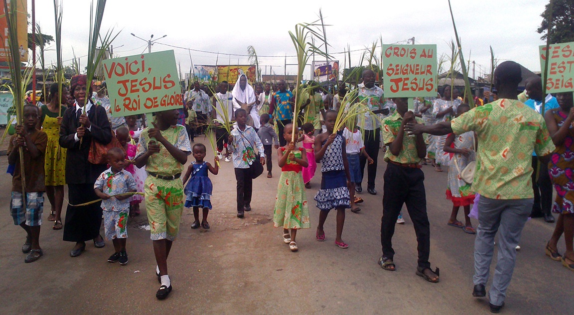 Crowds waving palm branches process through the streets of Port-Bouet, Ivory Coast, on Passion/Palm Sunday. This joyful scene is repeated all over the country by Ivorian United Methodists and Catholics. Photo by Isaac Broune, UM News.