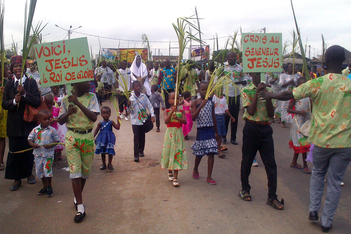 Crowds waving palm branches process through the streets of Port-Bouet, Ivory Coast, on Passion/Palm Sunday. This joyful scene is repeated all over the country by Ivorian United Methodists and Catholics. Photo by Isaac Broune, UM News.
