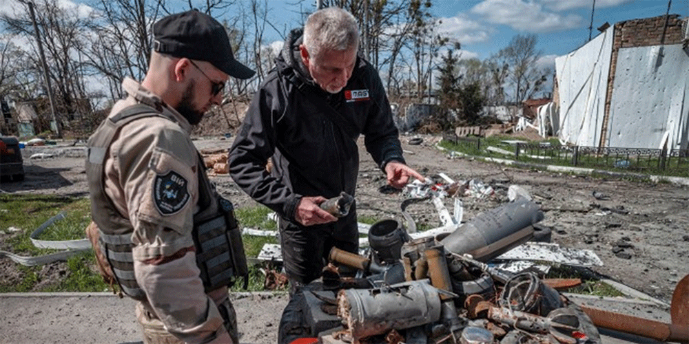 A MAG personnel inspects a variety of explosive ordnance. PHOTO: Sean Sutton/MAG