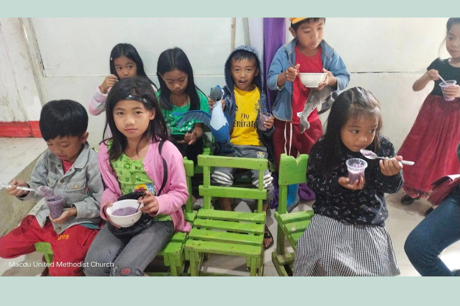 Children at Macdu UMC in the Philippines enjoy a snack made with ube sweet potato