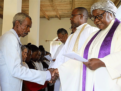 Members of Ambodifasika United Methodist Church are confirmed by Bishop Joaquina Filipe Nhanala (right) during a special service in Ambodifasika, Madagascar, on Feb. 27. To the bishop’s right is the Rev. João Sambô, assistant to the bishop in the Mozambique Episcopal Area. Photo by Alvin Makunike, UM News.
