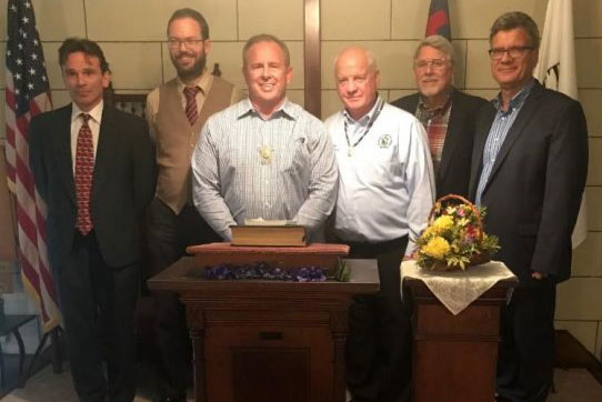 Representatives of the General Board of Global Ministries, the General Commission on Archives and History, and the Wyandott Nation gather at a podium. Image courtesy the General Board of Global Ministries of The United Methodist Church.