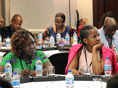 Jaka Joice Damiano Lokolo (left), women president from the Uganda-South Sudan Annual Conference, and Zoleka Primrose Masiza, young adults president from the South Africa Provisional Annual Conference, follow proceedings during the Global Ministries Africa Mission Consultation April 17-19 in Maputo, Mozambique. The meeting was to chart the way forward for mission on the continent. Photo by the Rev. Isaac Broune, UM News.