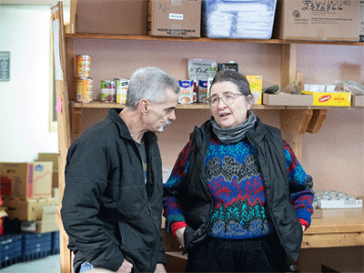 Jimmie Hutson visits with the Rev. Christina DowlingSoka at the Willow (Alaska) Community Food Pantry. DowlingSoka is the co-pastor of Willow United Methodist Church, which hosts the food pantry. She also serves as superintendent of the Alaska Conference.