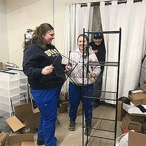 Putting up shelving at the Thrift Store. Photo by Rev. Linda Baldock.