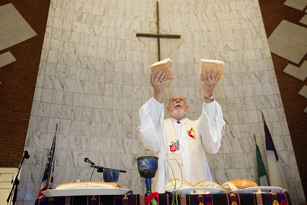 Bishop Joel Martínez blesses the elements of Holy Communion during opening worship at the 2011 MARCHA meeting at the Lydia Patterson Institute in El Paso, Texas. Photo by Mike DuBose, UM News.