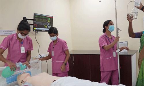 In their pink uniforms, scholarship recipients train with nursing teachers using a hi-tech robotic mannequin at the College of Nursing, Christian Medical College, Vellore.