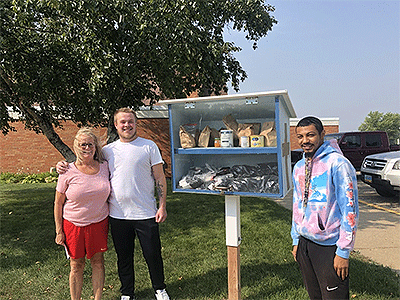 Friends, Ian and Terrance from Project Bee help fill the Blessing Boxes. Courtesy photo.