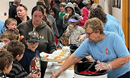 People in line for the meal at the neighborhood block party at Vincent UMC in Minot. Photos from Facebook.
