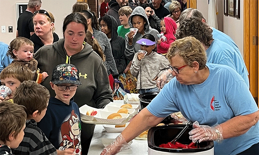 People in line for the meal at the neighborhood block party at Vincent UMC in Minot. Photos from Facebook.