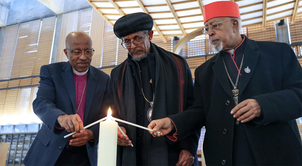 Ethiopian church leaders light a candle - symbol of common unity in Christ at the chapel of the Ecumenical centre:  Rev. Dr Yonas Yigezu Dibisa, president of the Evangelical Church Mekane Yesus, H.G. Archbishop Petros, general secretary of the Holy Synod of the Ethiopian Orthodox Tewahedo Church; and H.E. Cardinal Berhaneyesus Souraphiel of the Ethiopian Catholic Church.  Photo:  Ivars Kupcis/WCC