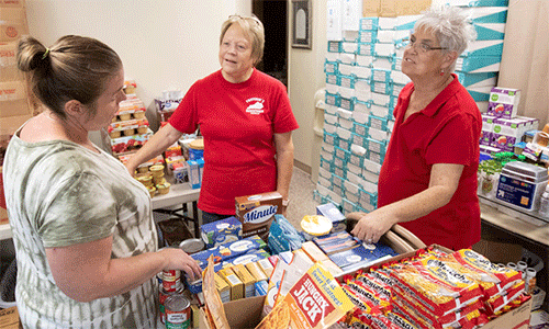 Flood survivor Rosemarie Peak (left) visits with volunteers Rose Calhoun (middle) and Debbie Holcomb while picking up relief supplies at United Methodist Mountain Mission in Jackson, Kentucky. (Photo: Mike DuBose, UM News)