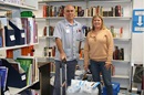 Shannon Wadlington (right) stands with mail carrier Rick Crocker amid shelves of books. Canterbury United Methodist Church in Birmingham, Ala., provides reading materials for inmate populations nationwide. Photo courtesy of the North Alabama Conference.