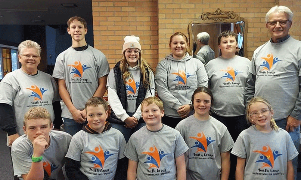 The United Methodist Youth Group at "Trick or Treat So Others Can Eat" sporting their new youth group t-shirts to make them easily identifiable within the community. Pictured, back row: Pastor Cheryl Nymann, Tristen Host, Tayah Anderson, Emmy Newsam, Easton Newsam, Kent Nyman. Front row: Bennett Kinsley, Weston Anderson, Royce Newsam, Maggie Dowling, and Julia Kinsley.