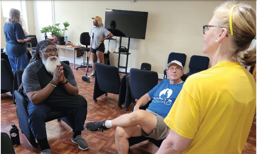 From Left: Pastor Tim Merrill and the Rev. Glenn Conaway talk with Helene Bolopue, a volunteer from First UMC Williamstown on the Day of Service July 29. Photo by John Coleman.
