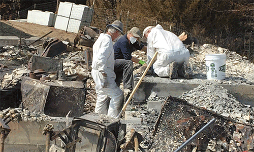 A California-Nevada Conference volunteer teams sifts through the ashes of a survivor’s former home at the survivor's request. (Photo: Courtesy of the California-Nevada Conference CDRC)