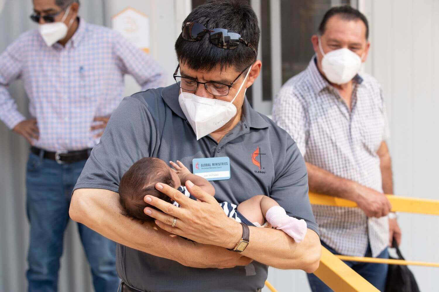 The Rev. Joel Hortiales cradles 11-day-old Dina at the Hospitalidad y Solidaridad migrant shelter in Mexico. Photo by Mike DuBose