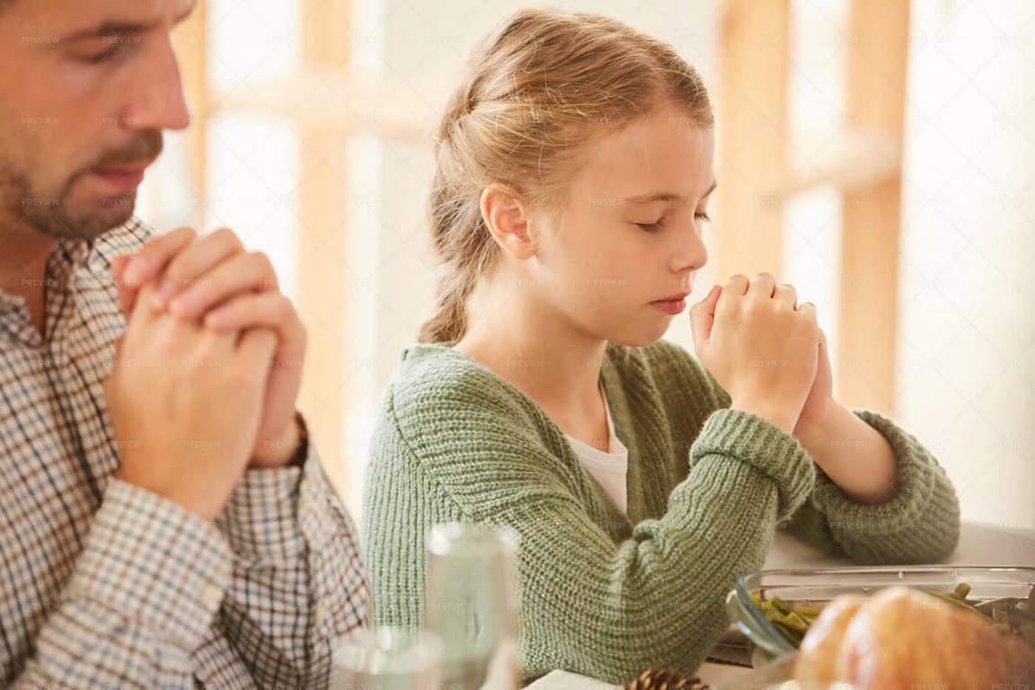 Father and daughter praying. Stock Image.